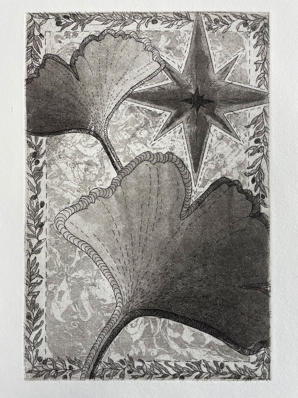 A printed image of two large leaves surrounded by a pattern of leaves and one large diamond. 