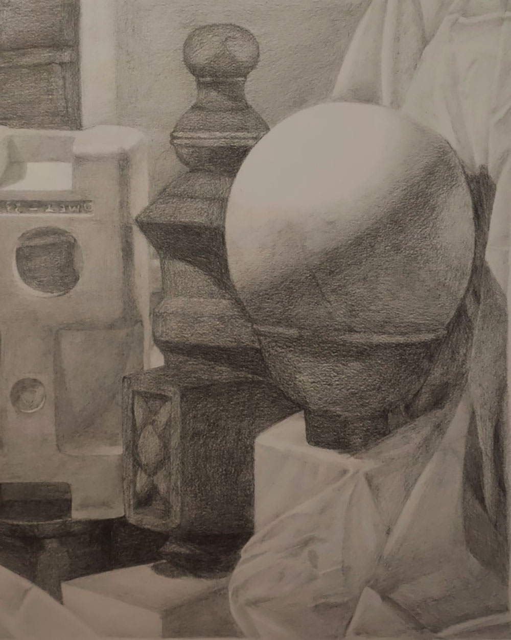 Still life drawing out of charcoal - specifically focused in on a sphere inside a bowl and a lamp stand. 