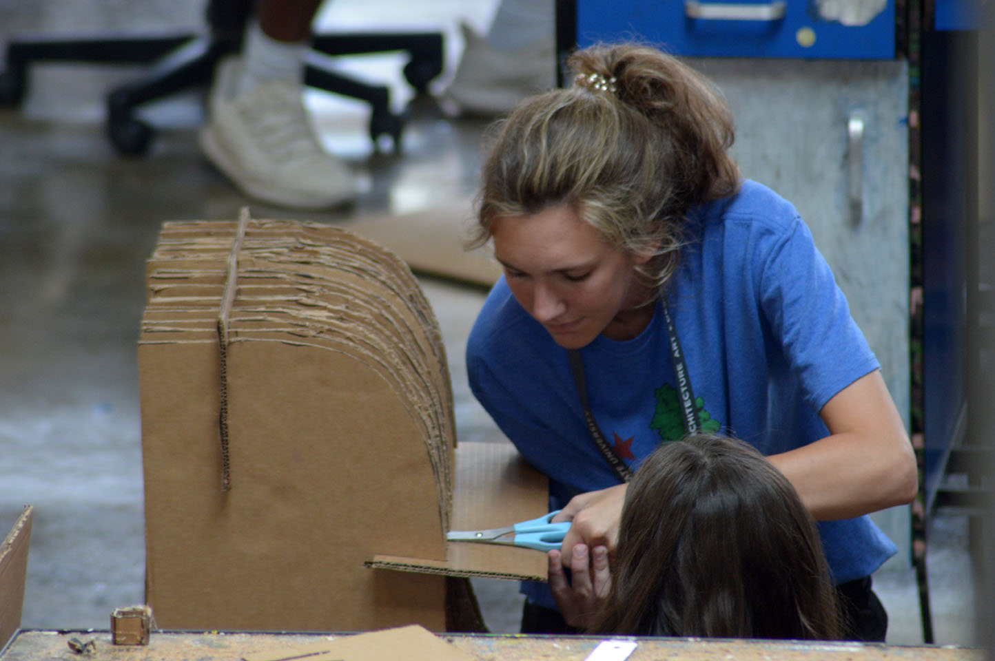 student working on cardboard frame