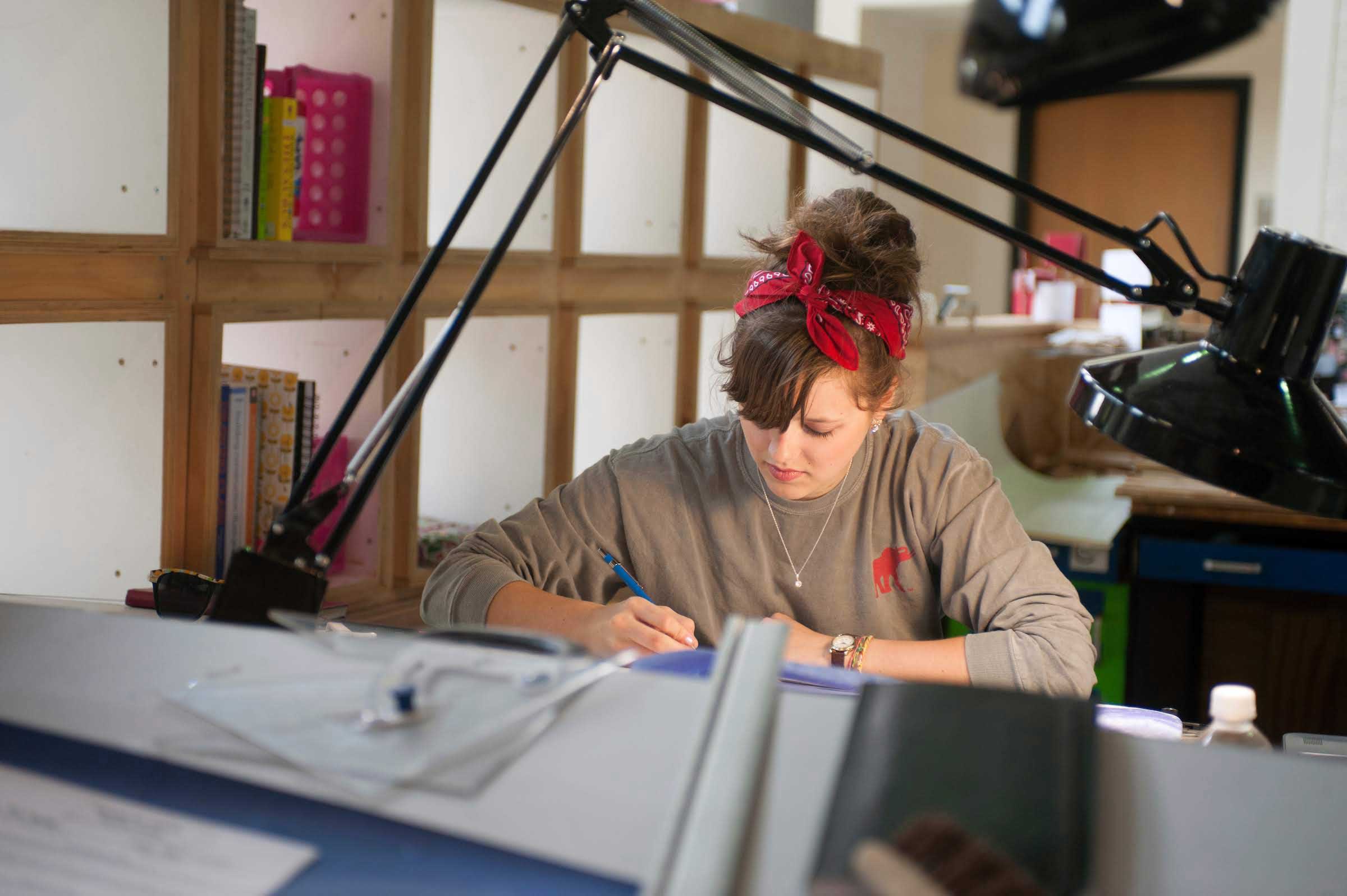architecture student works at studio desk