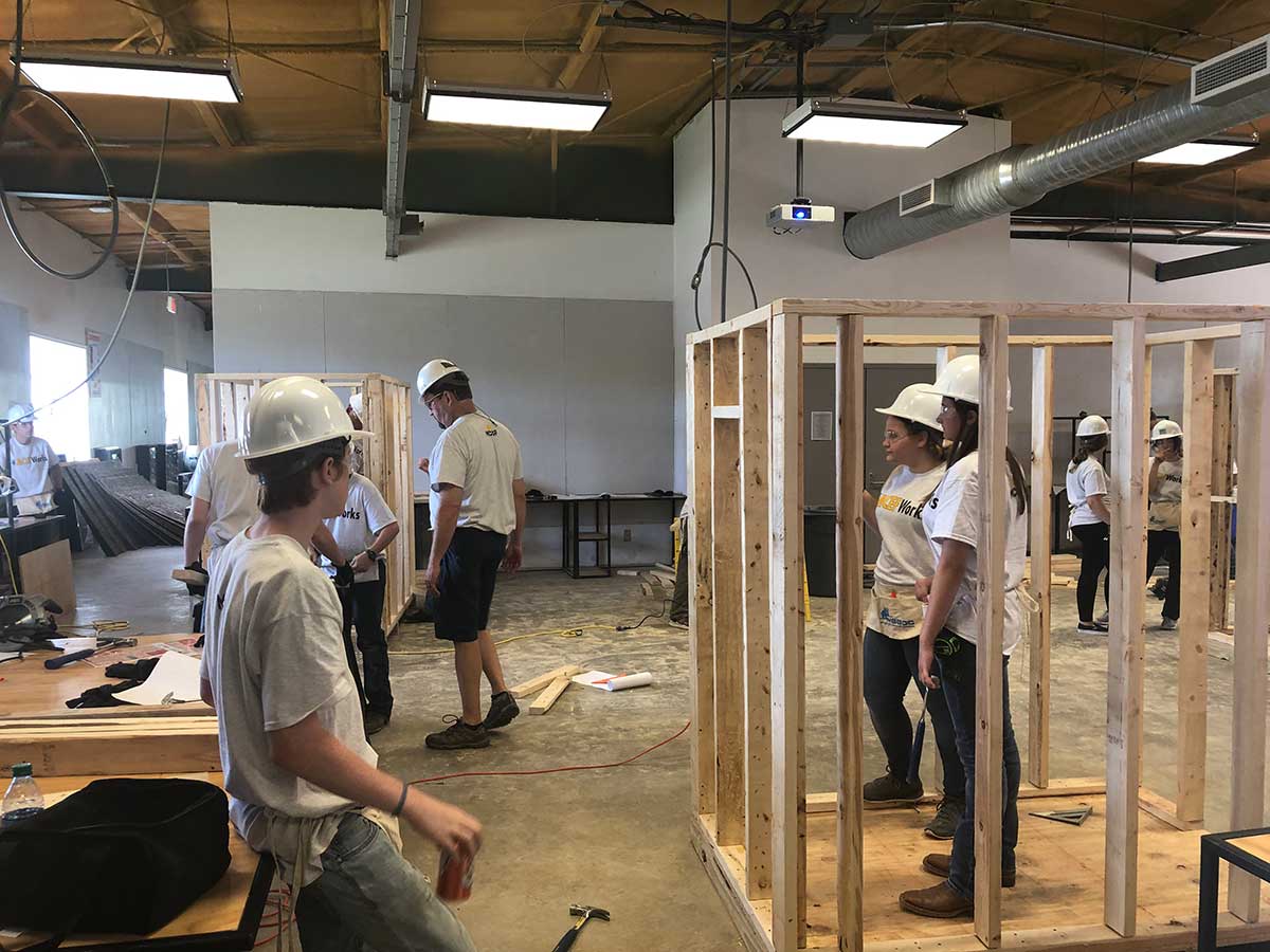 campers work on framing shooting house
