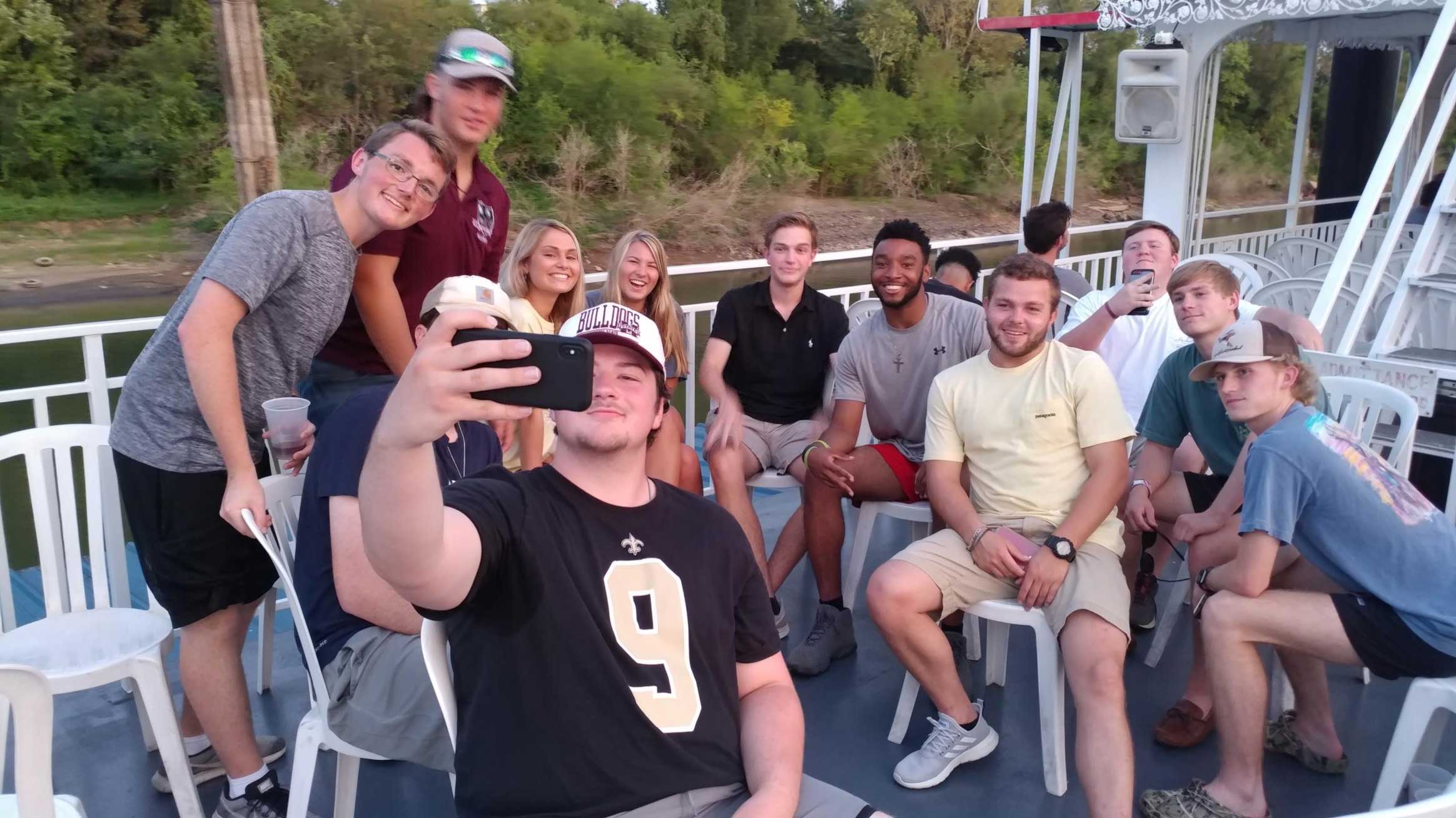 Mississippi State building construction science freshmen gathered on river boat cruise in Memphis taking a selfie