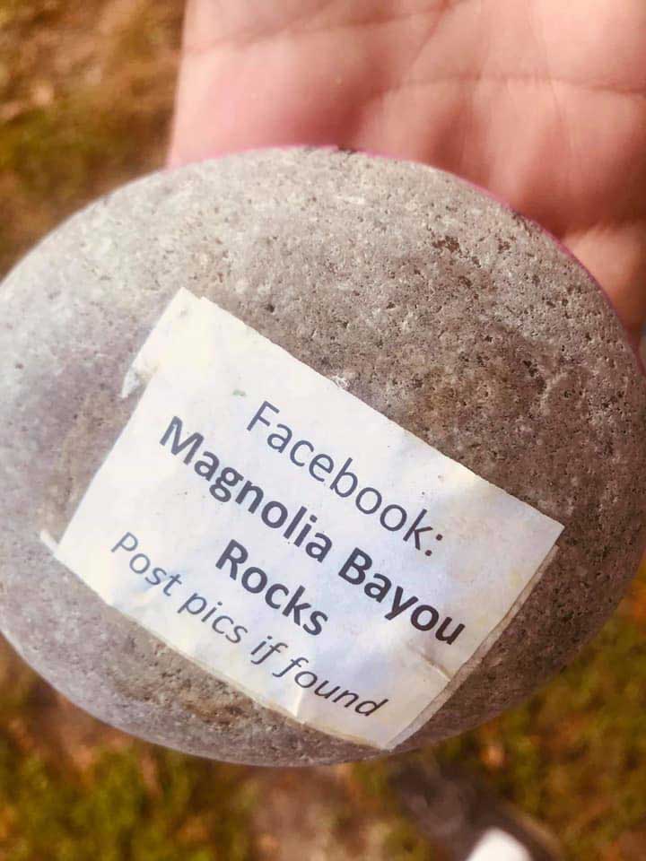 rock shown with typed paper taped on: &quot;Facebook: Magnolia Bayou Rocks - post pics if found.&quot;
