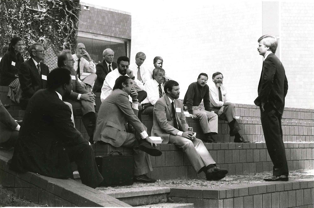 Dr. Michael Fazio sits at top of stairs with a group, second from left