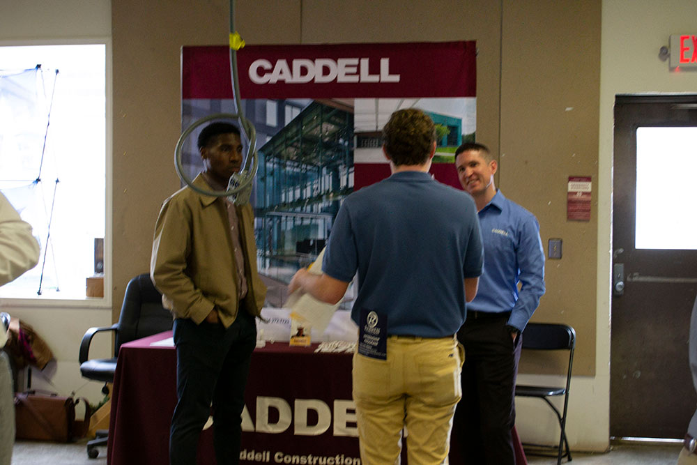 students talk with company representatives at the spring 2020 Building Construction Science Program career fair in Howell Building