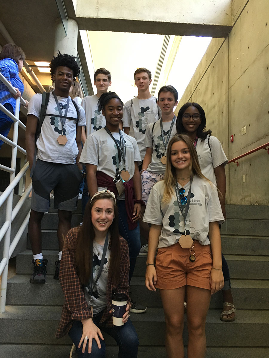 a group of campers and their counselor pose on the stairs in Giles Hall