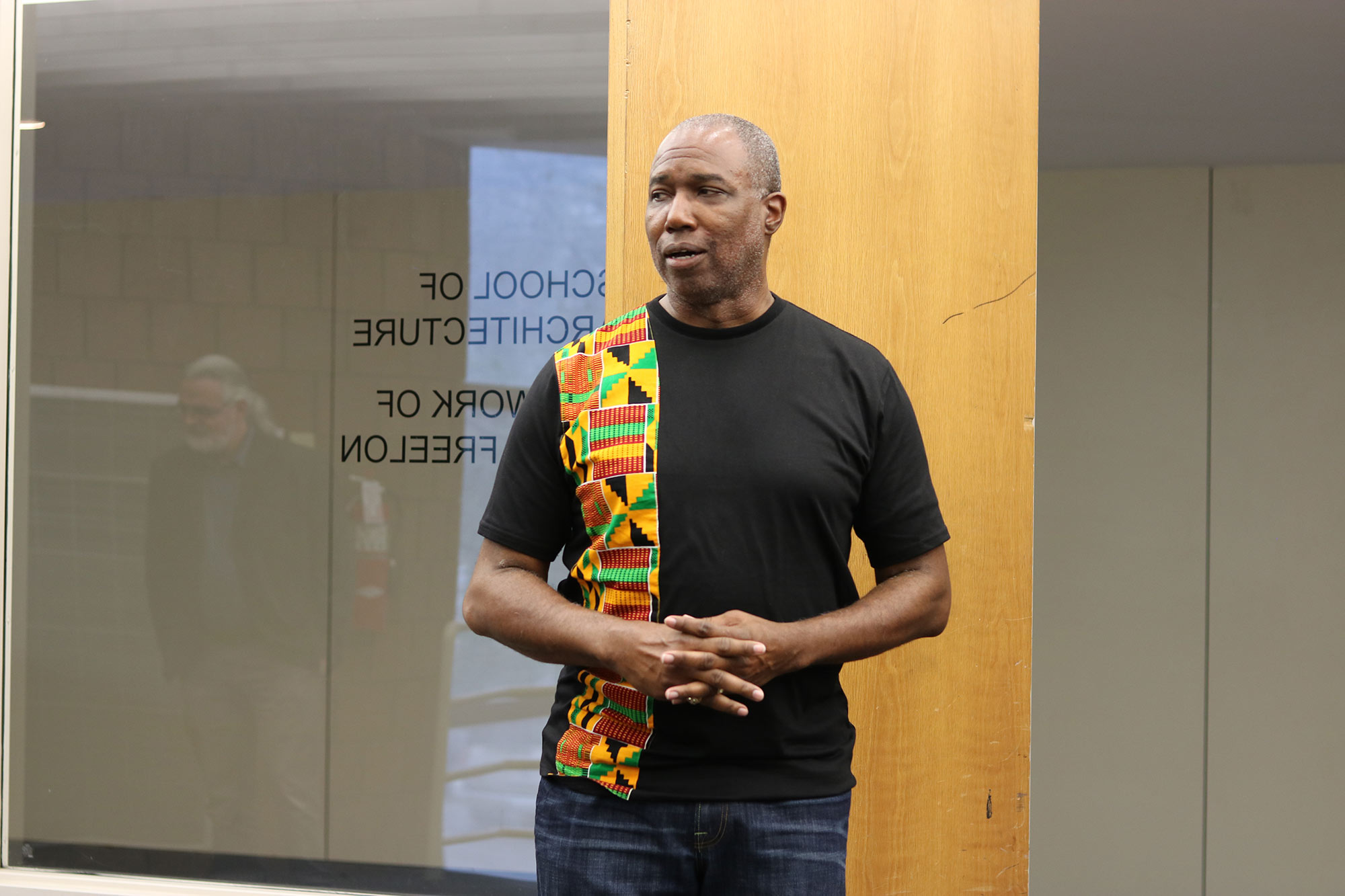 Professor Christopher Hunter speaks to guests in the Charlotte and Richard McNeel Gallery during a reception for &quot;The Work of Philip Freelon&quot; exhibit 