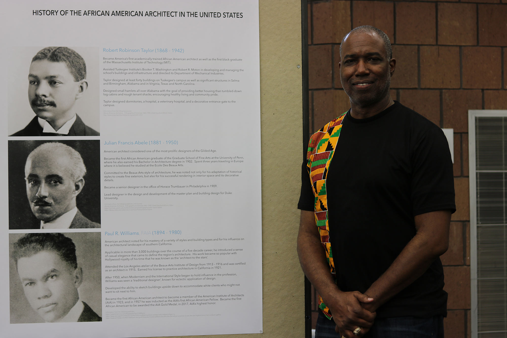 Professor Christopher Hunter poses in front of board in the Charlotte and Richard McNeel Gallery during a reception for &quot;The Work of Philip Freelon&quot; exhibit 