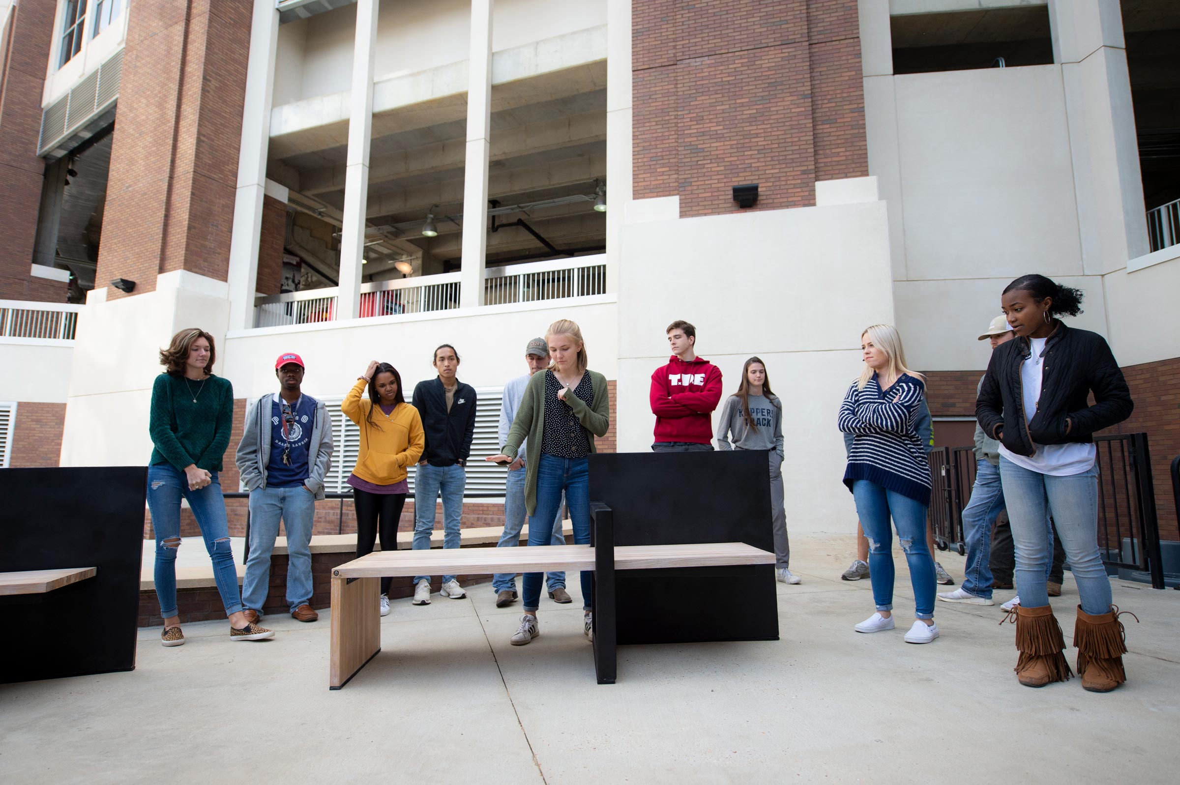 Ruthie Southall, a member of group one, explains the features of their handicap accessible bench during Architecture-Building Construction Science bench project presentations.