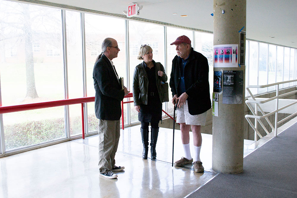 left to right: Michael Berk, Kimberly Brown, and Dan Camp talk at the top of the stairs in Giles Hall