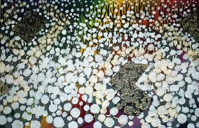 Painting of white balls of cotton over a rainbow background.