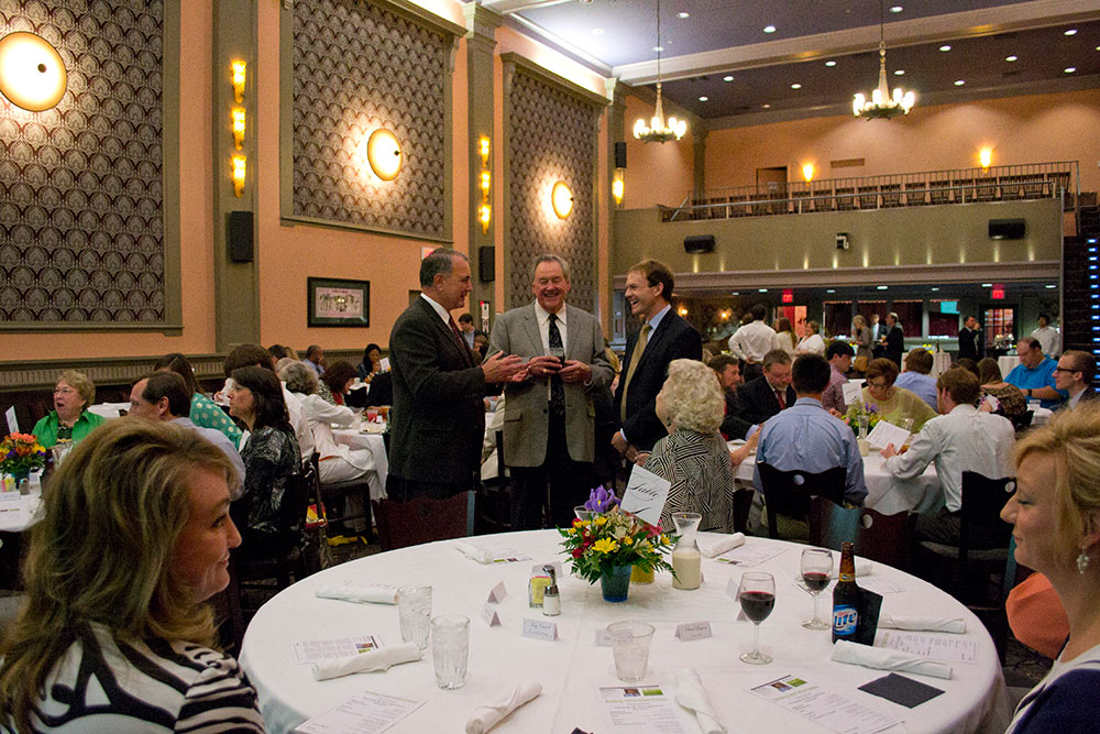 guests mingle at the banquet - center - Tony Carroll, Robert Harrison, Nathan Moore