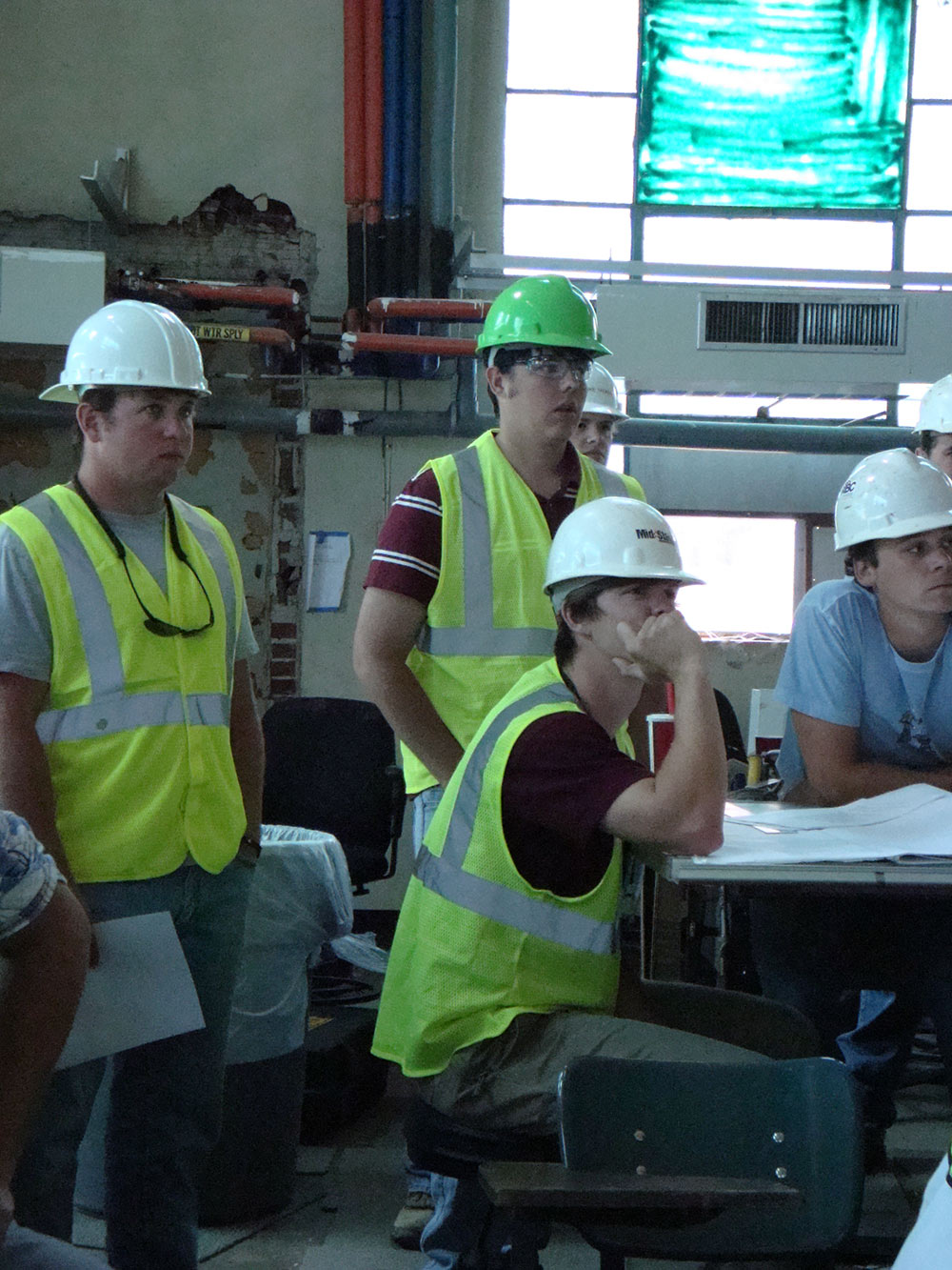 group all looking one direction - wearing hard hats