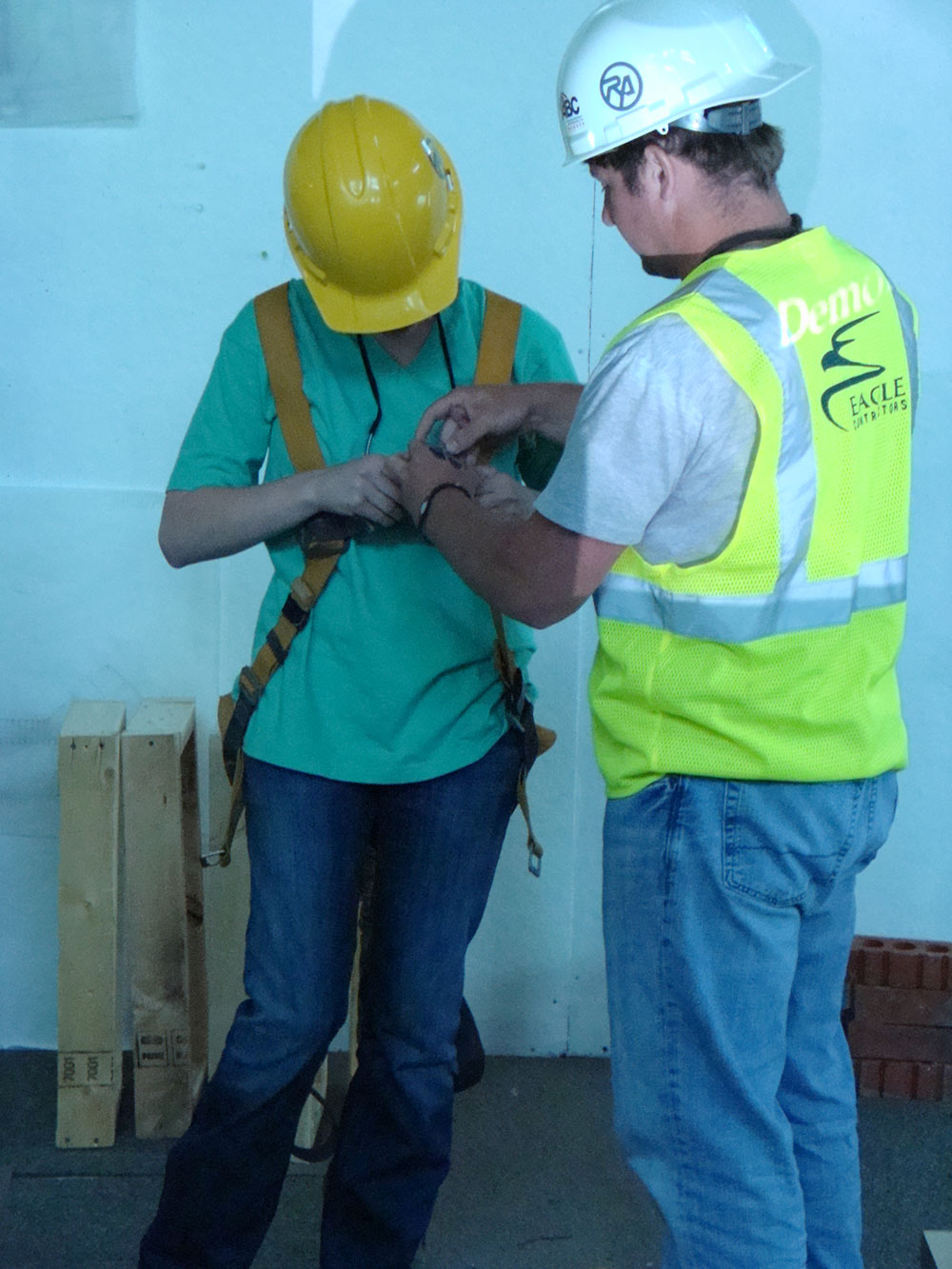 person helping another put on harness