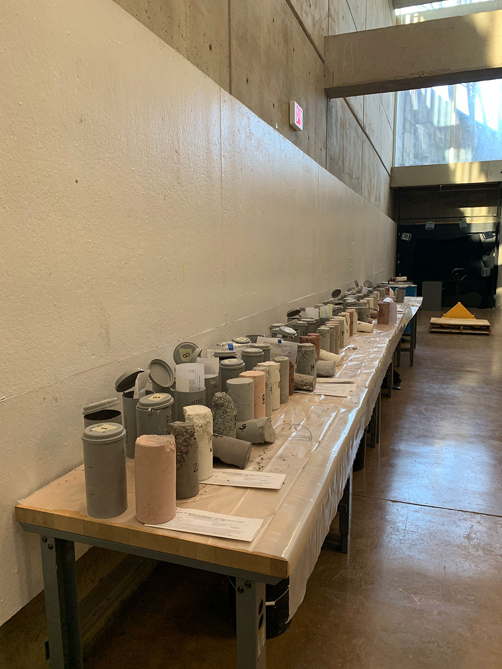 long line of concrete cylinders on table