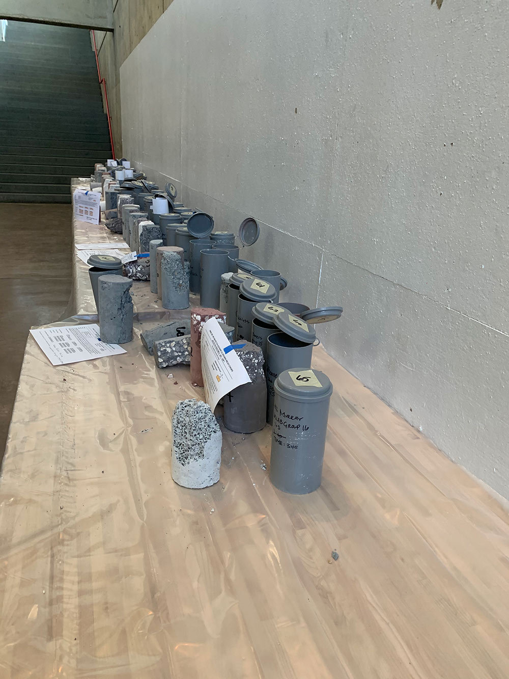 concrete cylinders lined up on table