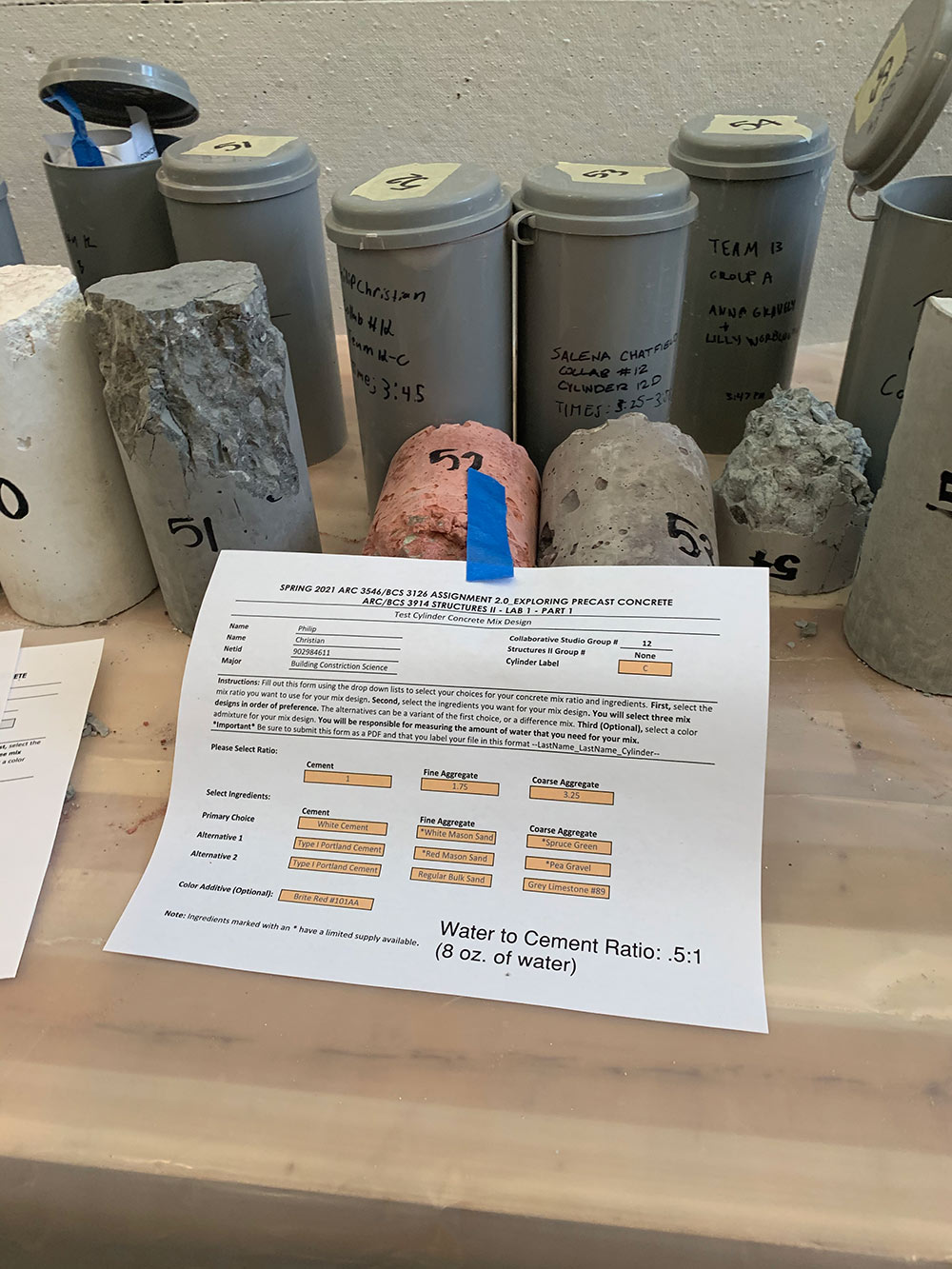 concrete cylinders with project printout taped in front