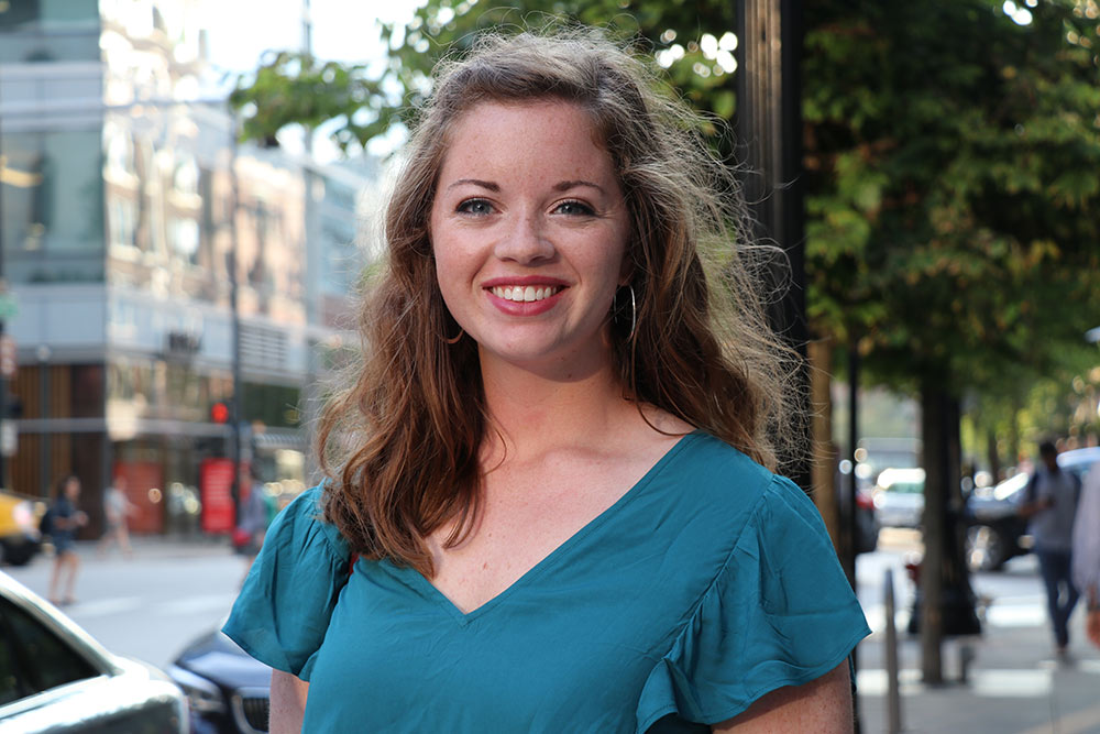 headshot of Emily Gafford with city background