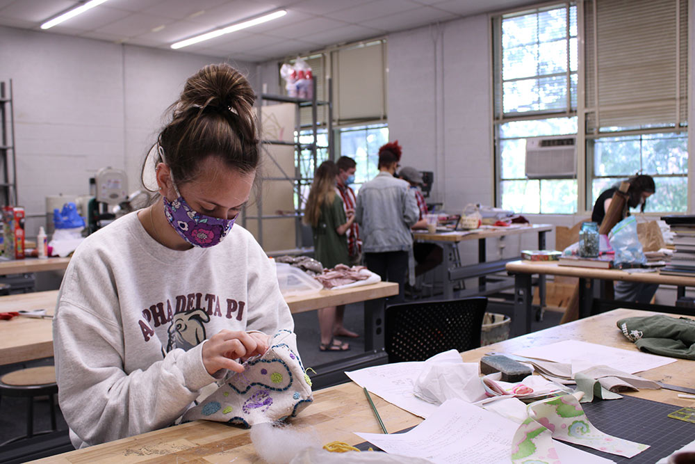 female student works on embroidery project