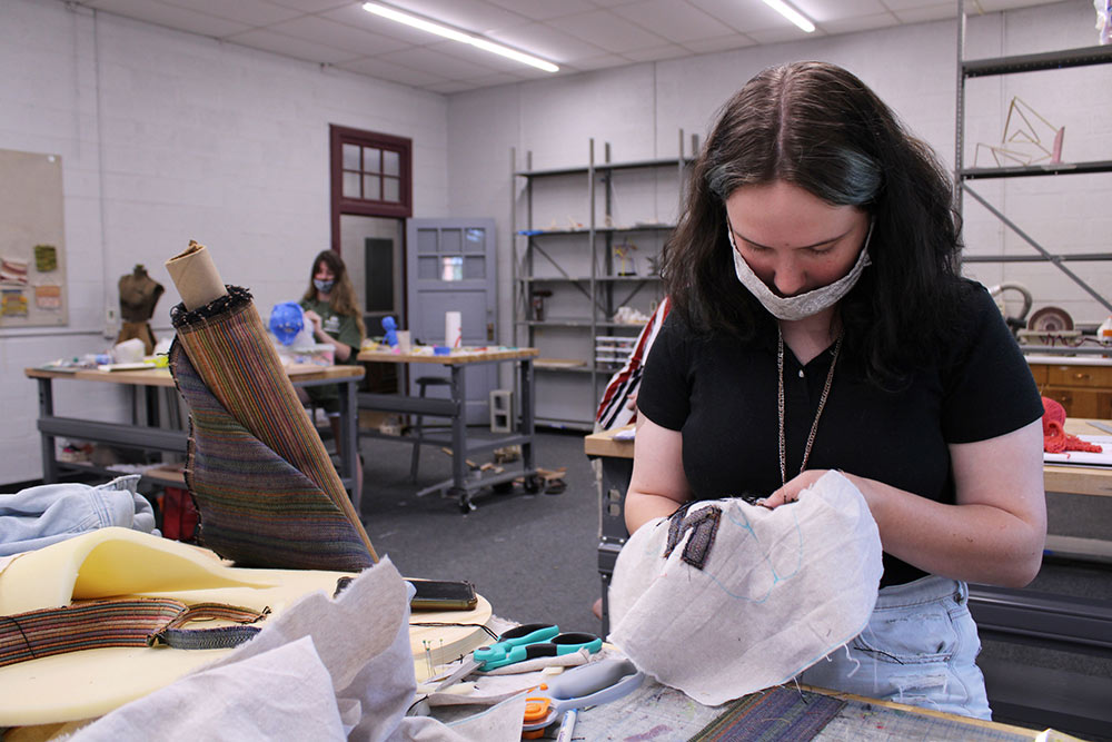 female student works on embroidery project