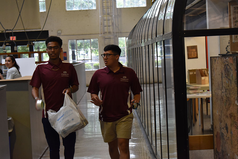 counselors carry supplies by first-year studio