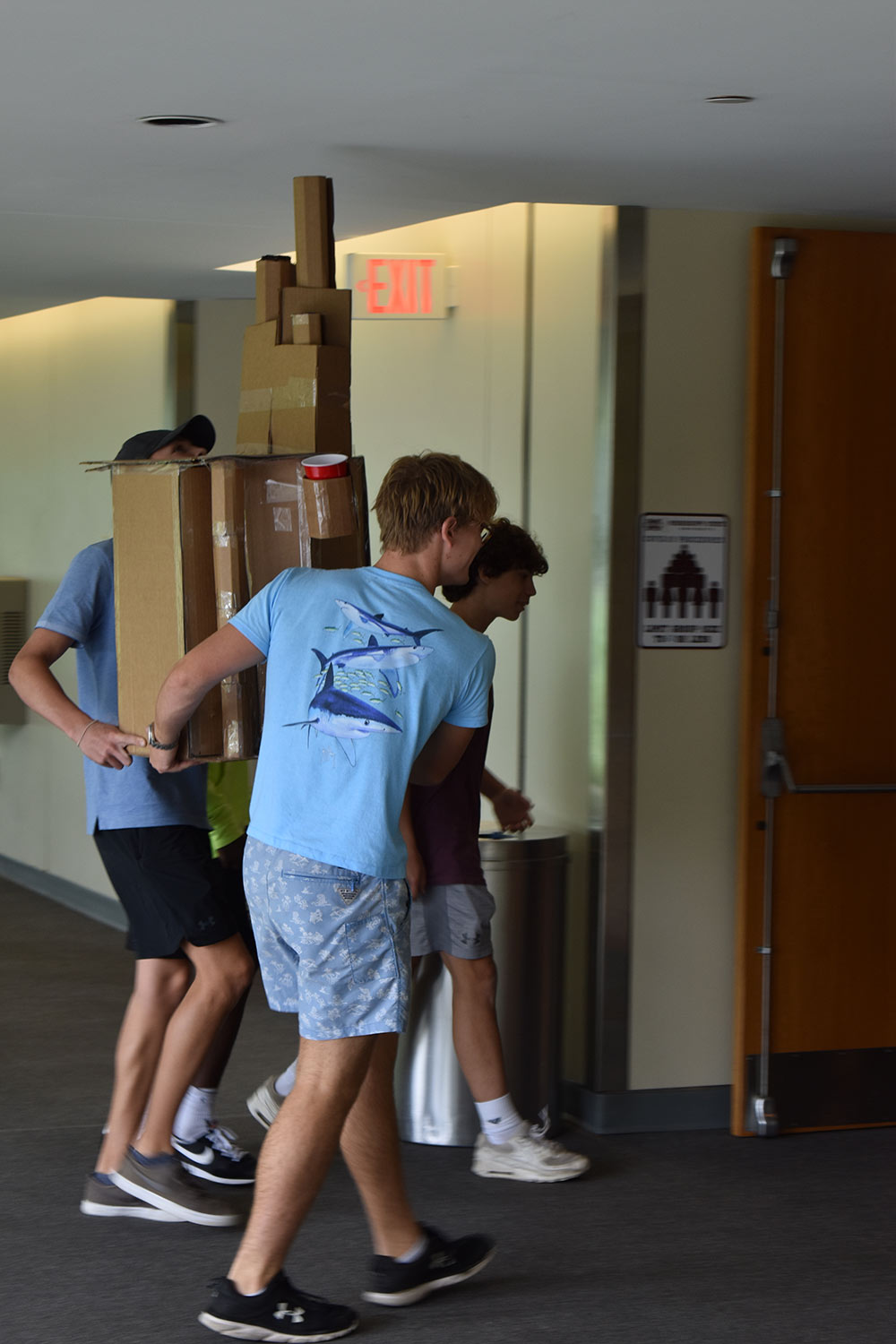team carries their cardboard lounge device