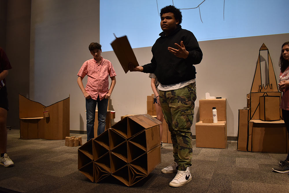 student presents cardboard project