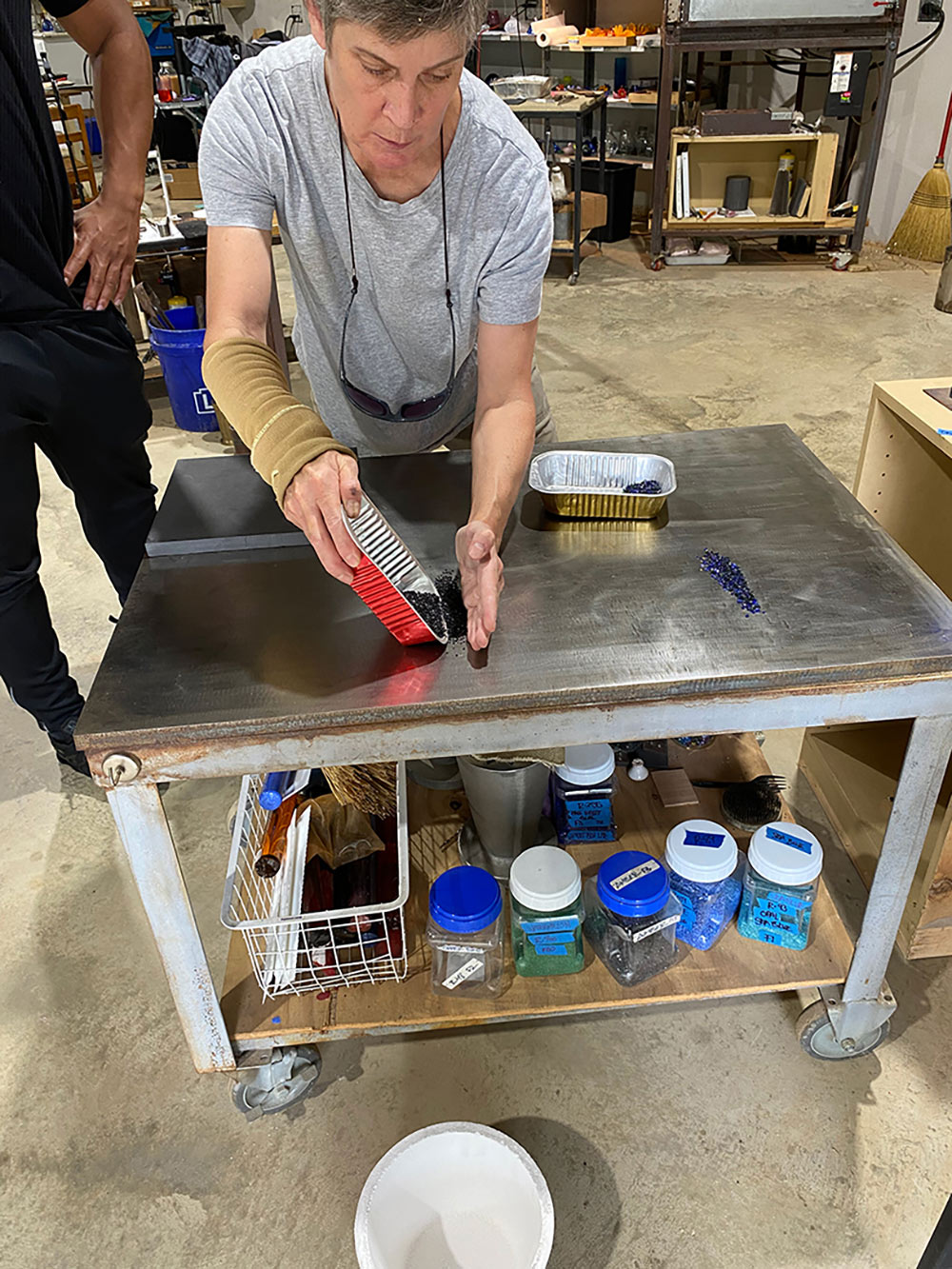 someone demonstrating with materials on metal table