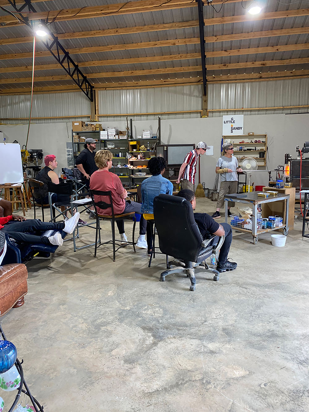 group sits and watches glass demonstration