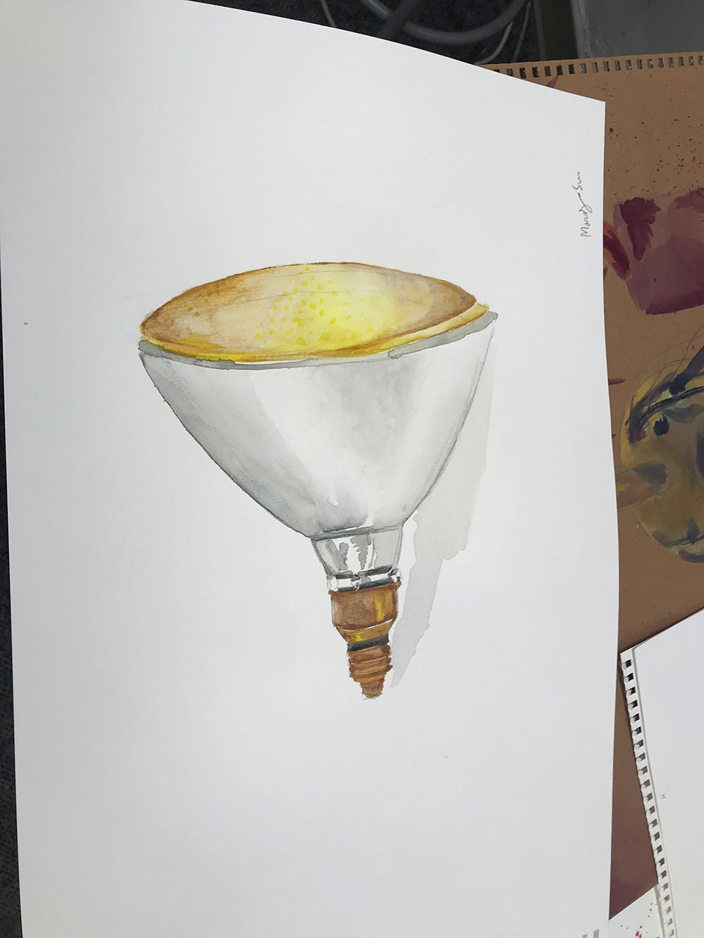 closeup of watercolor painting of light bulb