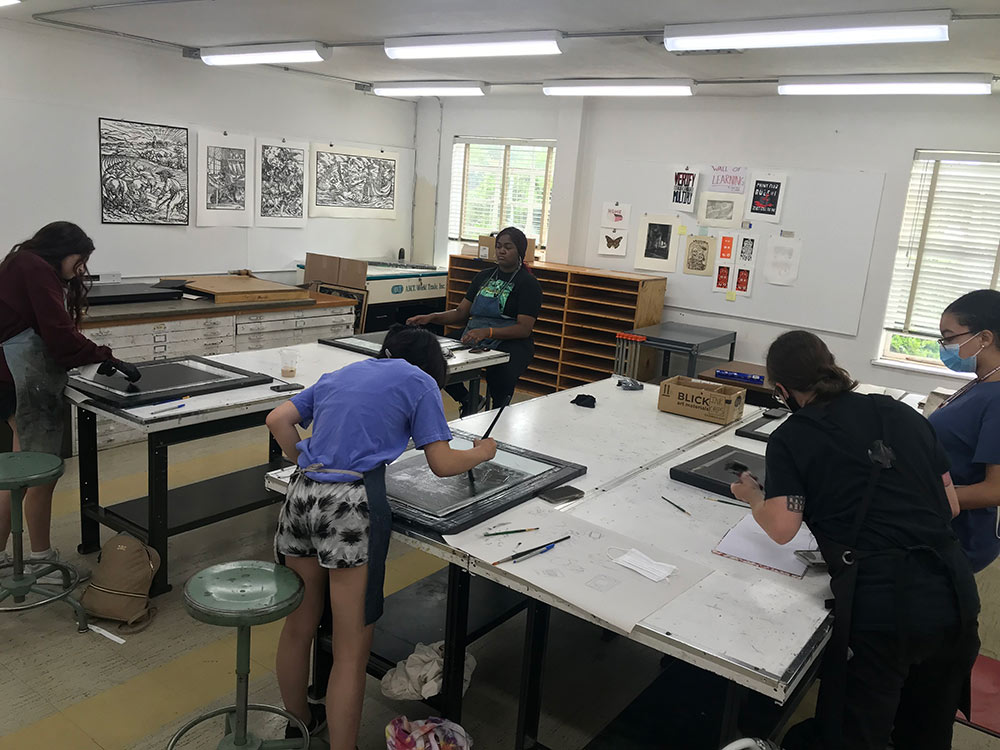 view of several campers working on monoprint project at tables