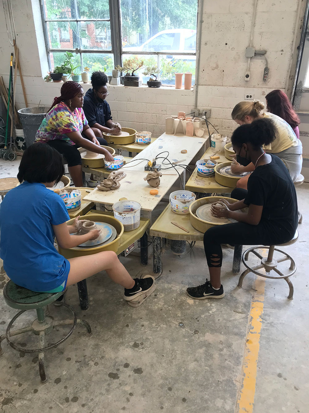 campers work in ceramics studio