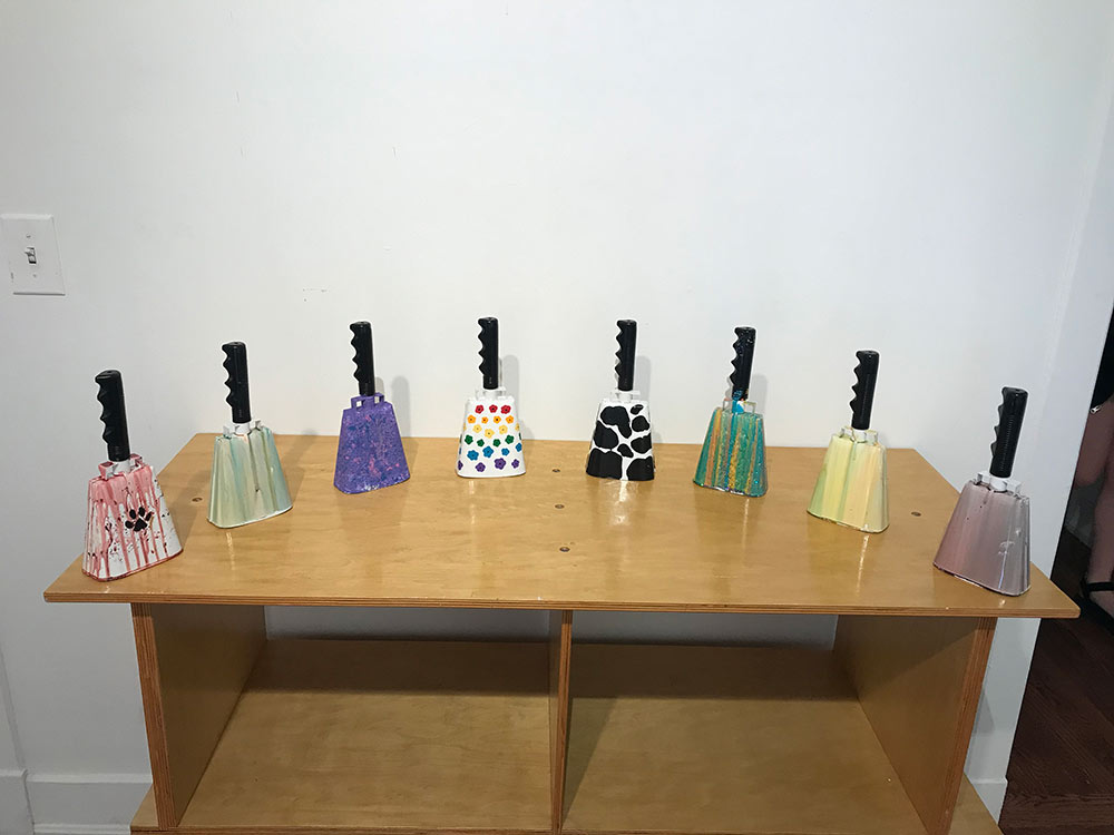 8 cowbells painted on table