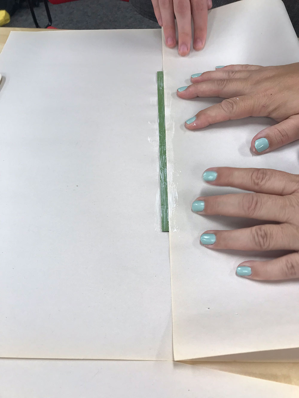 view of hands on paper