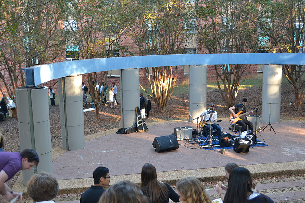A live band performs for participants of the workshop in the pavilion outside of Giles.