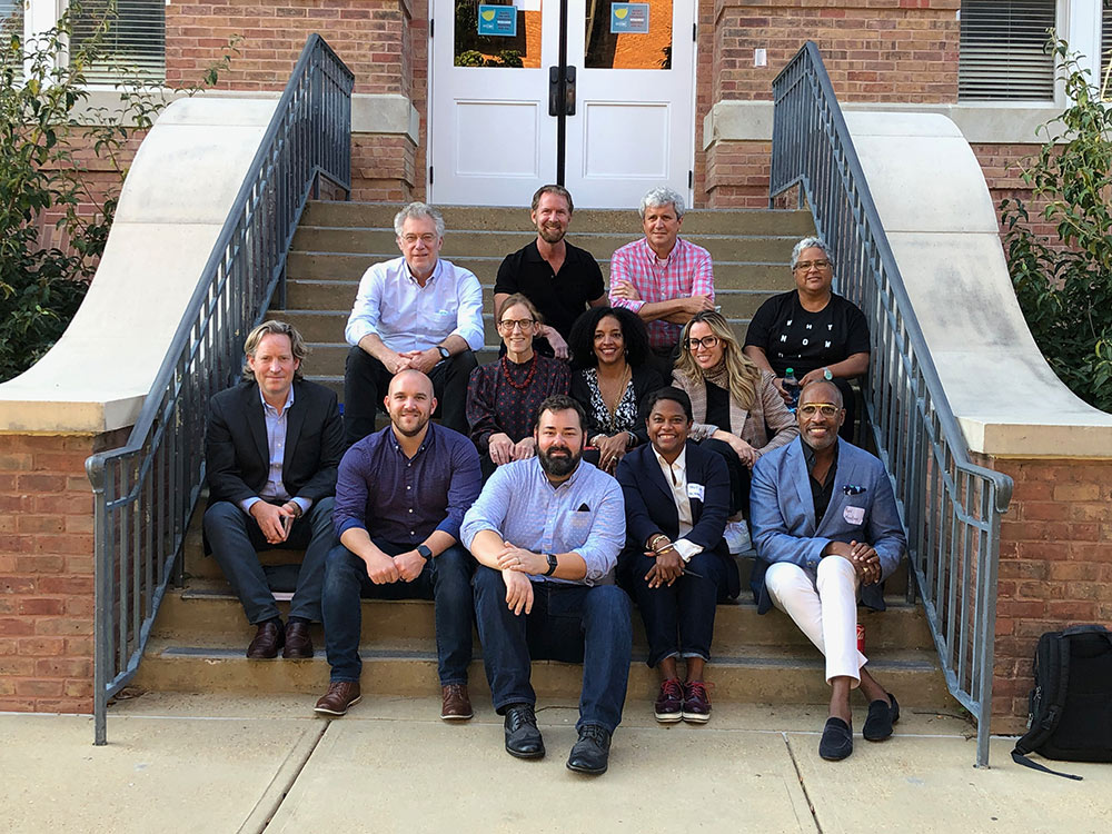 Design Leadership Foundation Professionals sit on the front steps of Montgomery Hall.