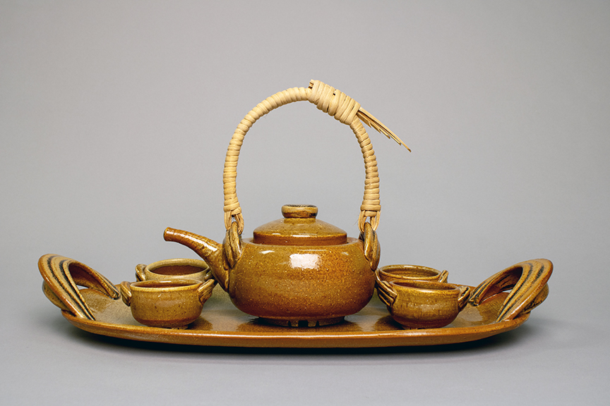 Ceramic tea set with platter, tea pot, and cups.