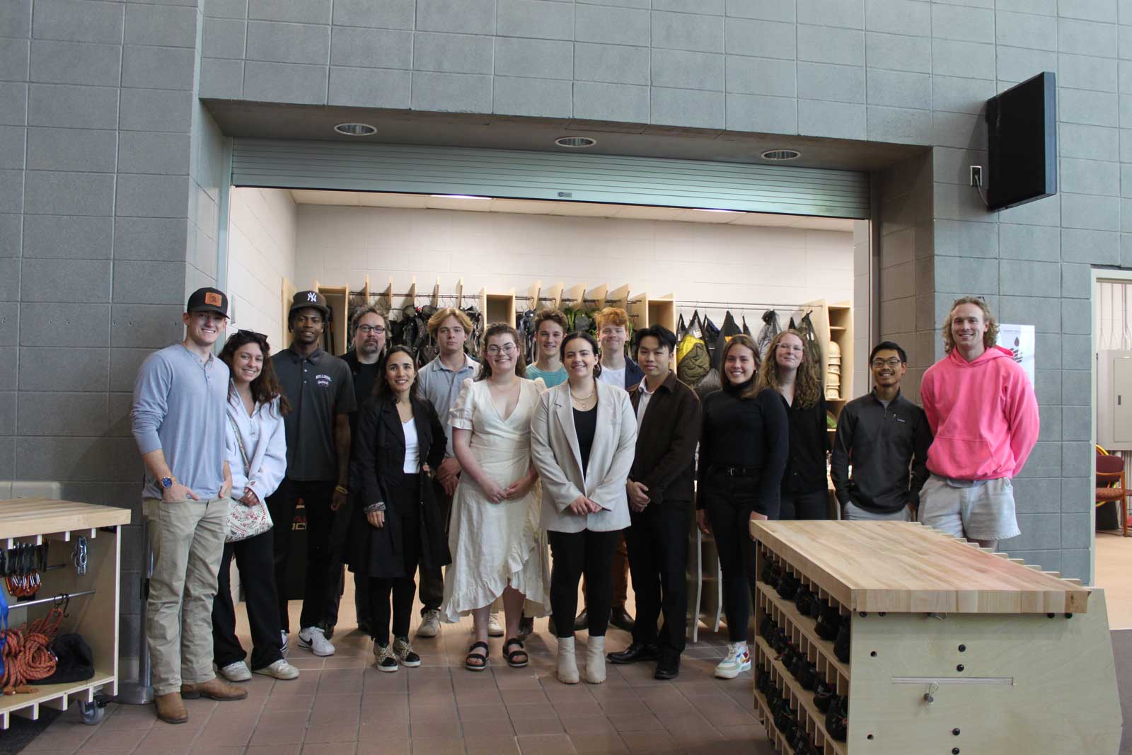 The students and their professors stand for a group photo in front of their project.