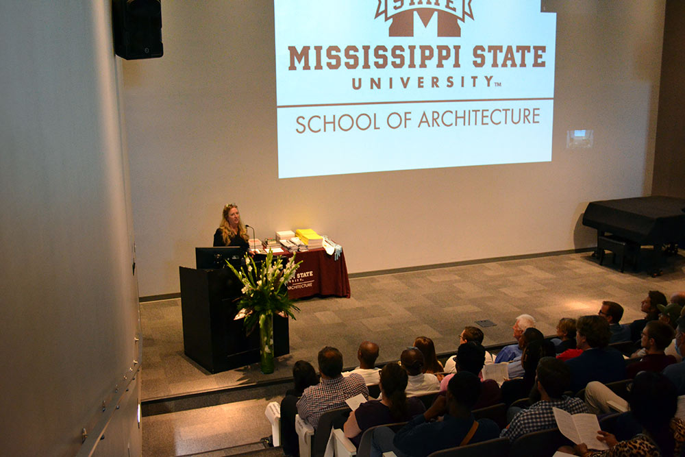 Kimberly Brown at podium before audience in the Robert and Freda Harrison Auditorium in Giles Hall
