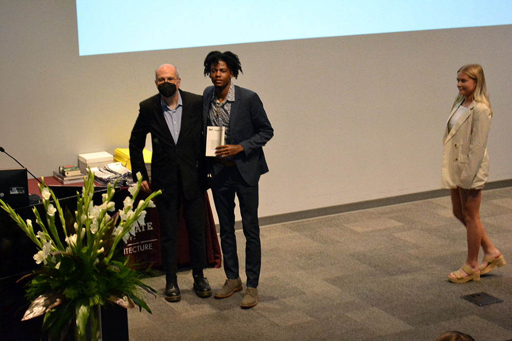 Professor John Poros presents the Third-Year Faculty Book Award to Du’Juan Brown 