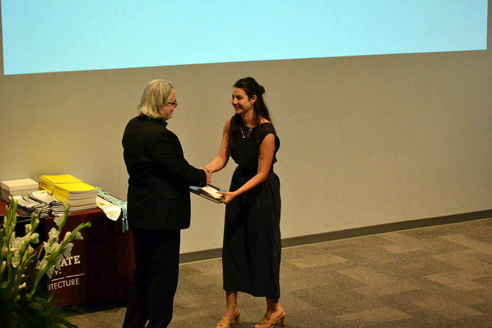 Associate Director Jassen Callender presents the Fifth-Year Faculty Book Award to Grace Sheridan