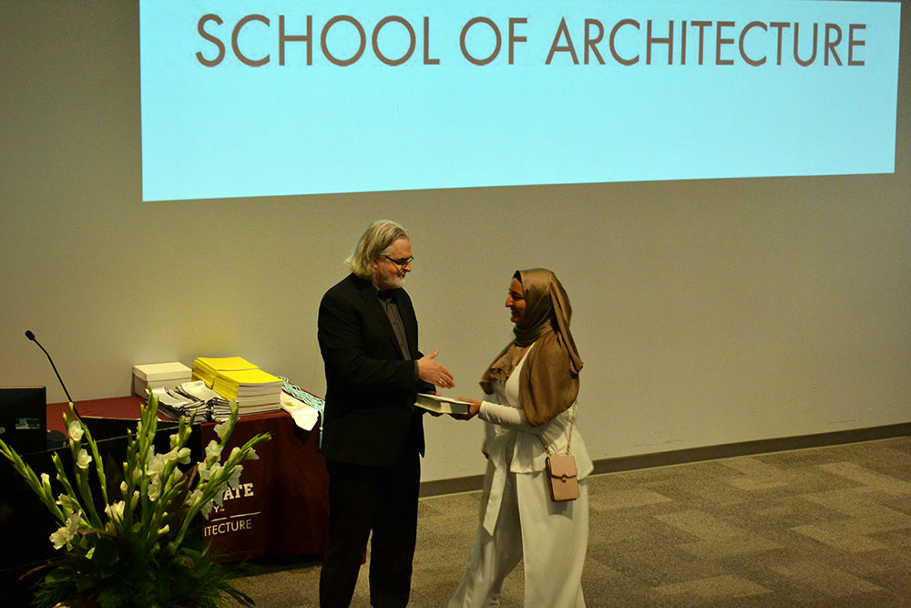 Nada Abdel-Aziz, right, accepts the Academic Achievement Award from Associate Director Jassen Callender