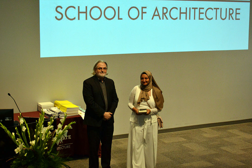 Nada Abdel-Aziz, right, accepts the Academic Achievement Award from Associate Director Jassen Callender