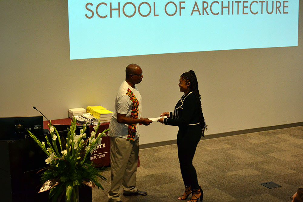 Jasmine Topps, right, received the Alpha Rho Chi Medal from Professor Christopher Hunter