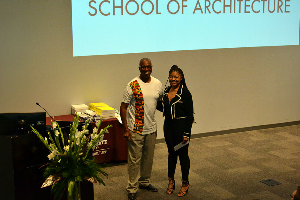 Jasmine Topps, right, received the Alpha Rho Chi Medal from Professor Christopher Hunter