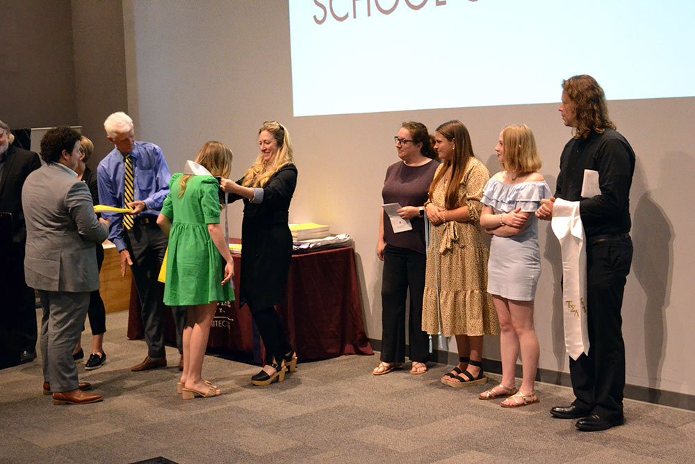 MSU S|ARC class of 2022 students receive their stoles and shake hands with faculty