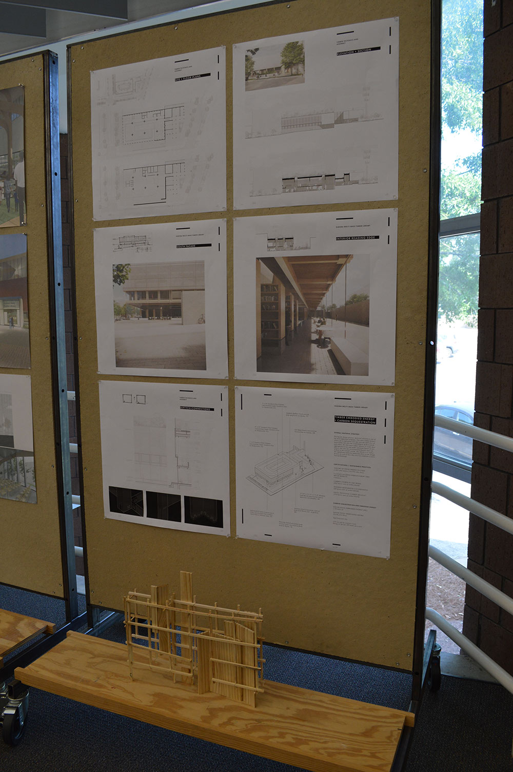A pin up board inside the gallery that features information about one of the projects.