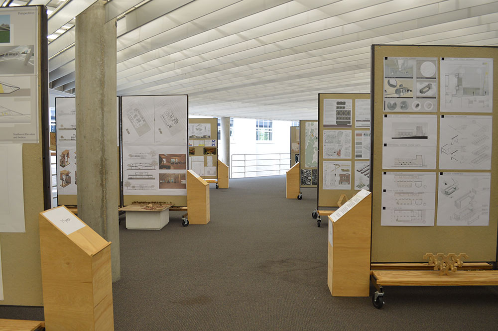 A view of the McNeal gallery with pin up boards of the projects on display.