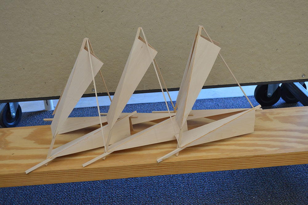 A wooden model created by a student that resembles a sailboat. 