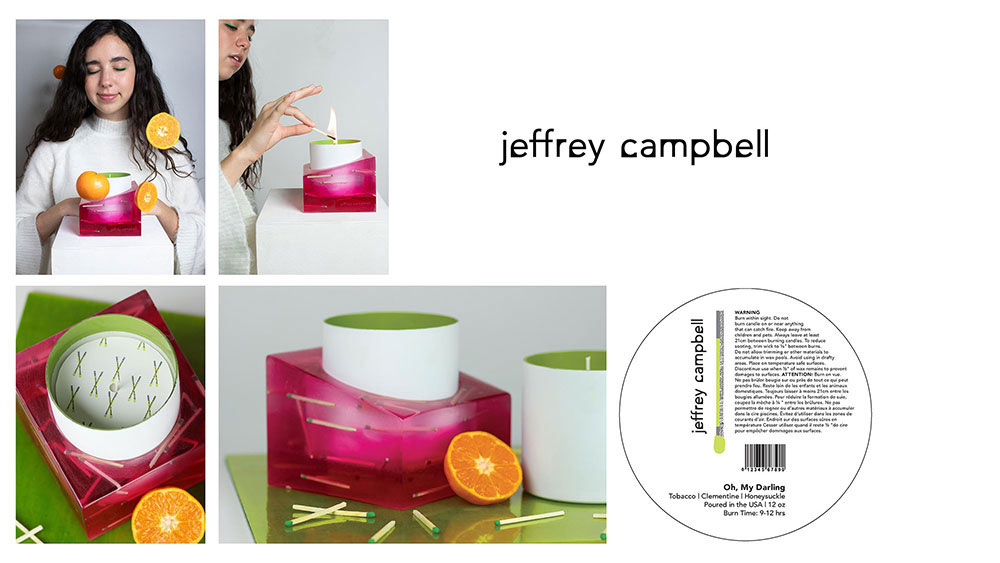 images of a candle designed by a student. The exterior of the candle is white, while the inside is a green color. It is photographed with slices of oranges surrounding it and green matches. 